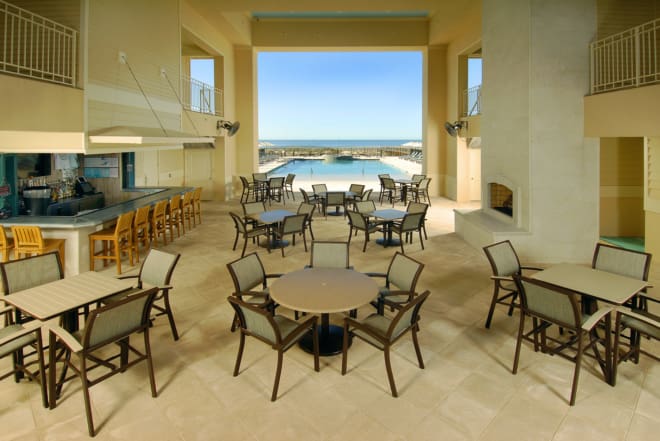 Telescope Casual outdoor dining furniture on a poolside patio